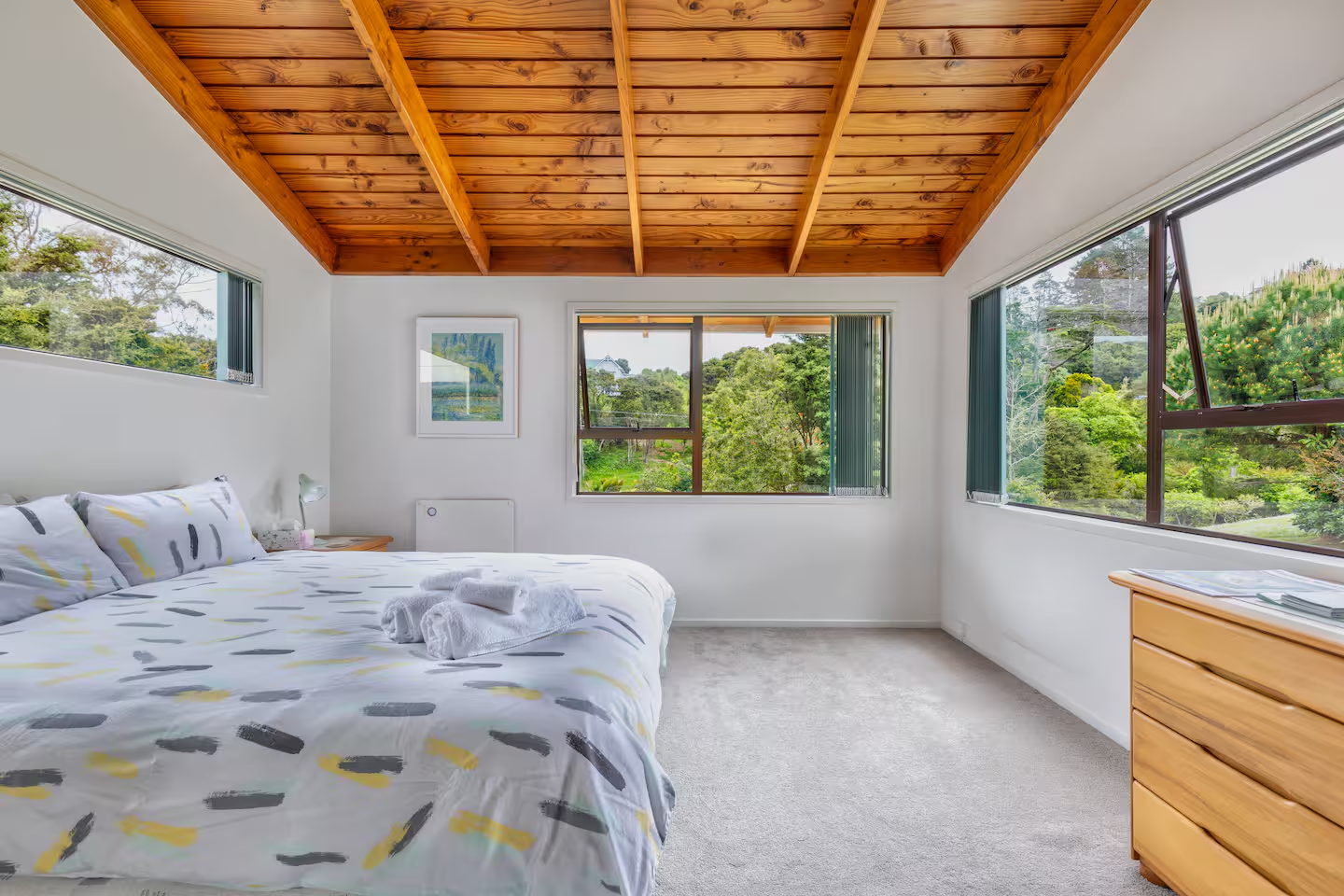 Palm Beach Tranquil B&B — bright, airy bedroom with native bush views and wooden ceiling beams